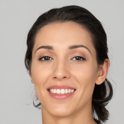 Joyful white young-adult female with medium  brown hair and brown eyes