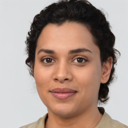 Joyful latino young-adult female with medium  brown hair and brown eyes