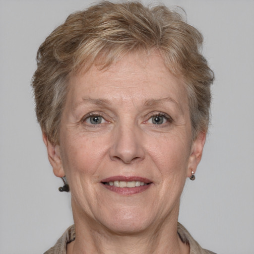 Joyful white middle-aged female with short  brown hair and grey eyes