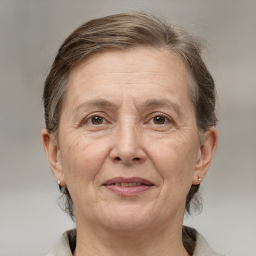 Joyful white middle-aged female with medium  brown hair and grey eyes