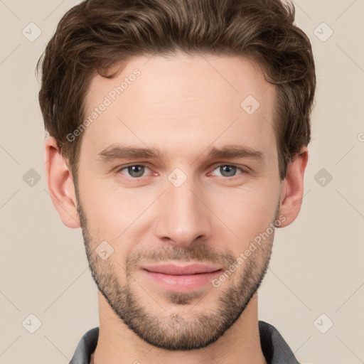 Joyful white young-adult male with short  brown hair and grey eyes