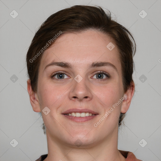 Joyful white young-adult female with short  brown hair and grey eyes