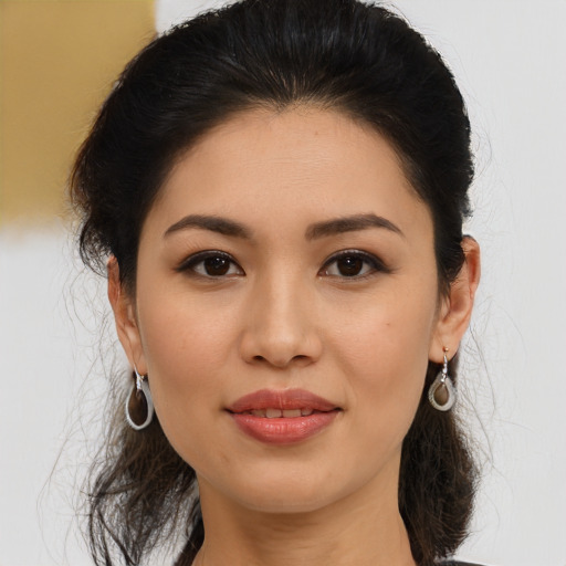 Joyful asian young-adult female with medium  brown hair and brown eyes