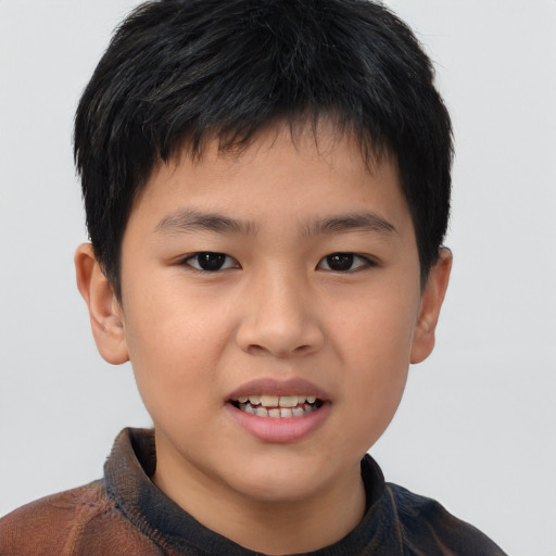Joyful asian child male with short  brown hair and brown eyes