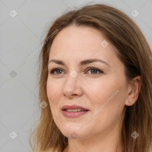 Joyful white adult female with long  brown hair and brown eyes