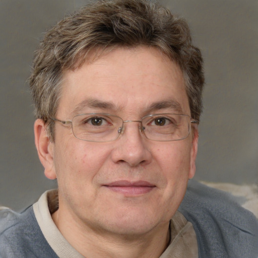 Joyful white adult male with short  brown hair and grey eyes