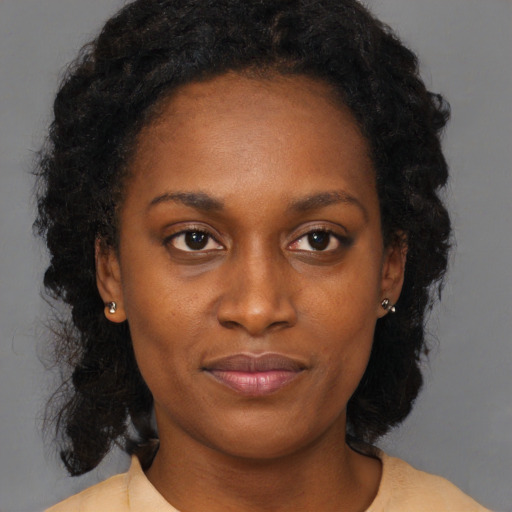 Joyful black young-adult female with medium  black hair and brown eyes