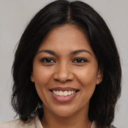 Joyful latino young-adult female with medium  brown hair and brown eyes