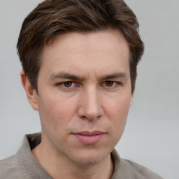 Joyful white adult male with short  brown hair and grey eyes