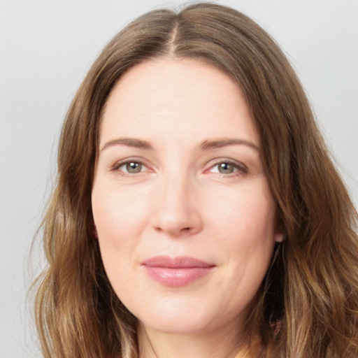 Joyful white young-adult female with long  brown hair and green eyes