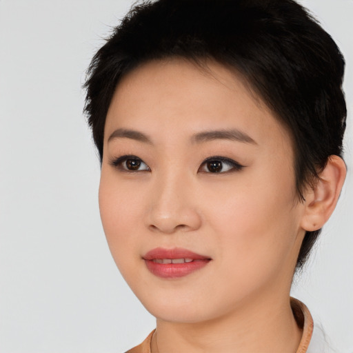 Joyful asian young-adult female with short  brown hair and brown eyes