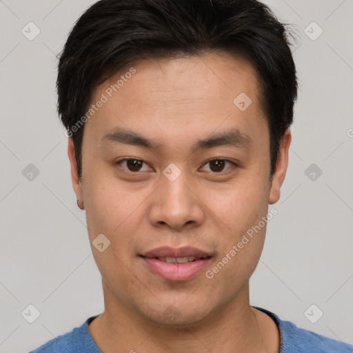 Joyful asian young-adult male with short  brown hair and brown eyes