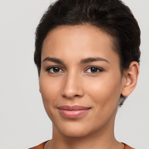 Joyful latino young-adult female with short  brown hair and brown eyes