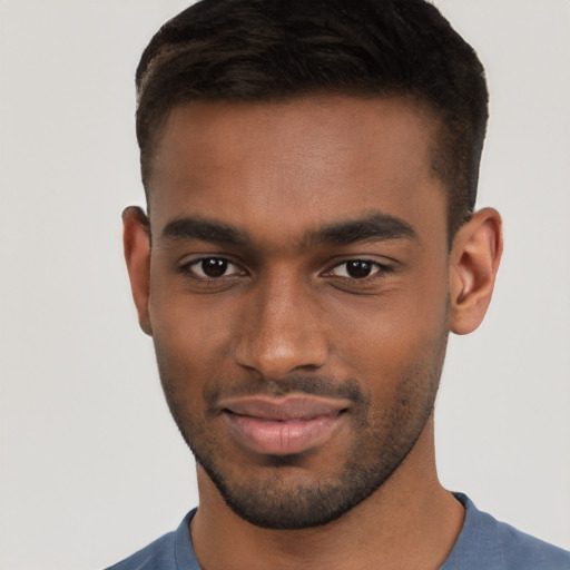 Joyful black young-adult male with short  brown hair and brown eyes