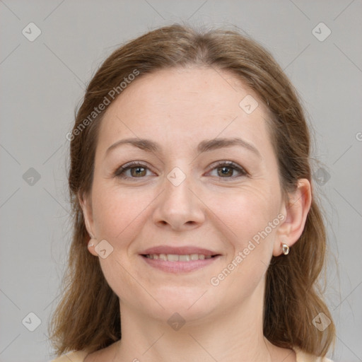 Joyful white young-adult female with long  brown hair and grey eyes