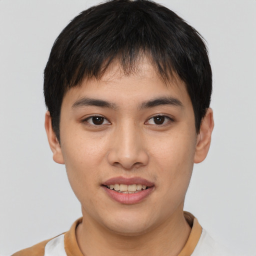 Joyful asian young-adult male with short  brown hair and brown eyes