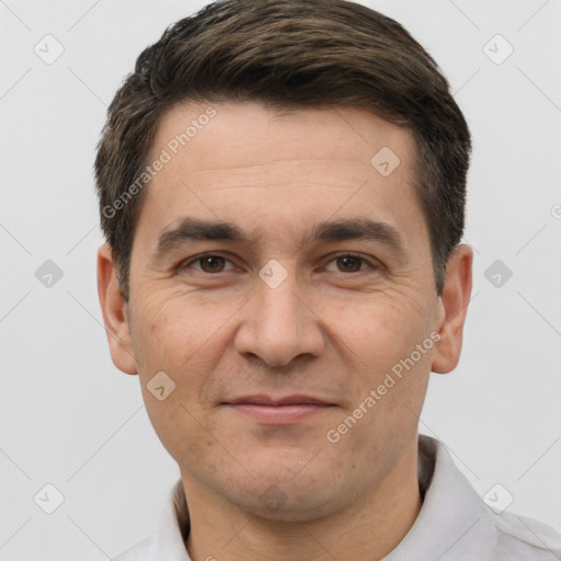 Joyful white adult male with short  brown hair and brown eyes