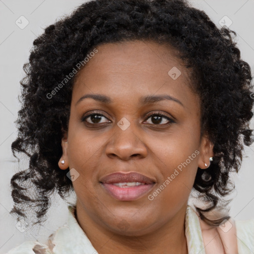 Joyful black young-adult female with long  brown hair and brown eyes