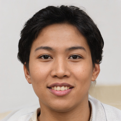 Joyful asian young-adult female with short  brown hair and brown eyes