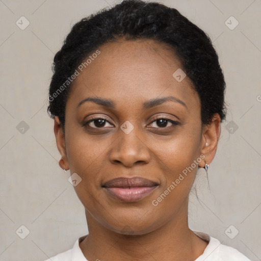 Joyful black young-adult female with short  black hair and brown eyes