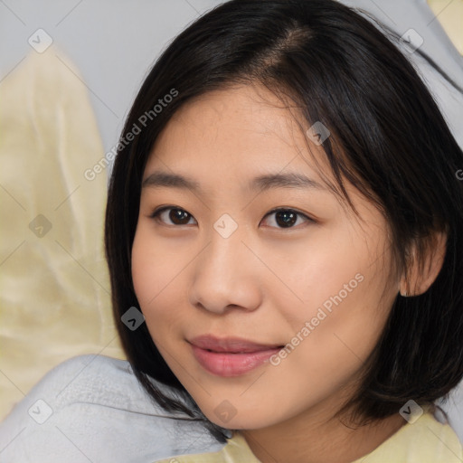 Joyful asian young-adult female with medium  brown hair and brown eyes