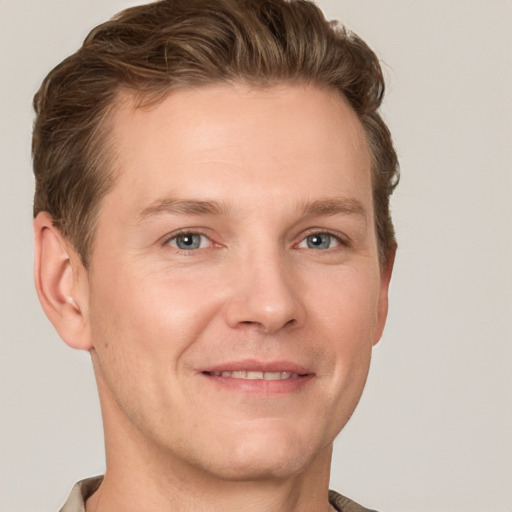 Joyful white adult male with short  brown hair and grey eyes