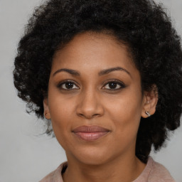 Joyful black adult female with medium  brown hair and brown eyes