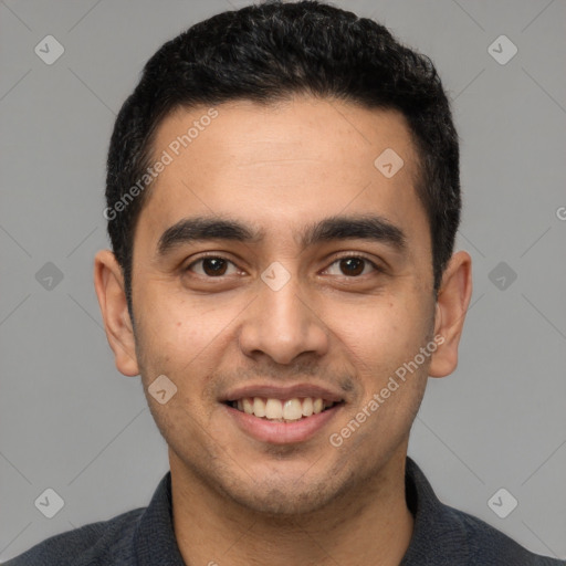 Joyful latino young-adult male with short  black hair and brown eyes