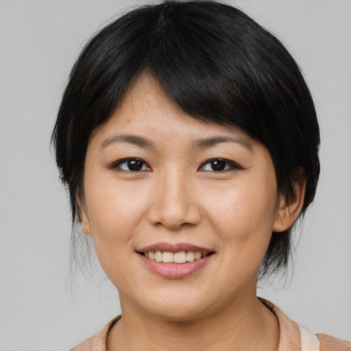 Joyful asian young-adult female with medium  brown hair and brown eyes