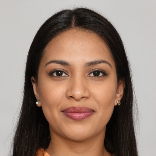 Joyful latino young-adult female with long  brown hair and brown eyes