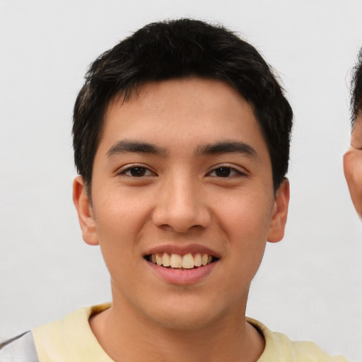 Joyful asian young-adult male with short  black hair and brown eyes