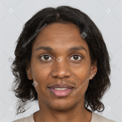 Joyful black adult female with medium  brown hair and brown eyes