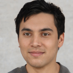 Joyful white young-adult male with short  black hair and brown eyes