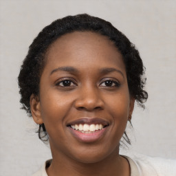 Joyful black young-adult female with medium  brown hair and brown eyes