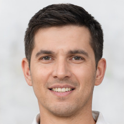 Joyful white young-adult male with short  brown hair and brown eyes