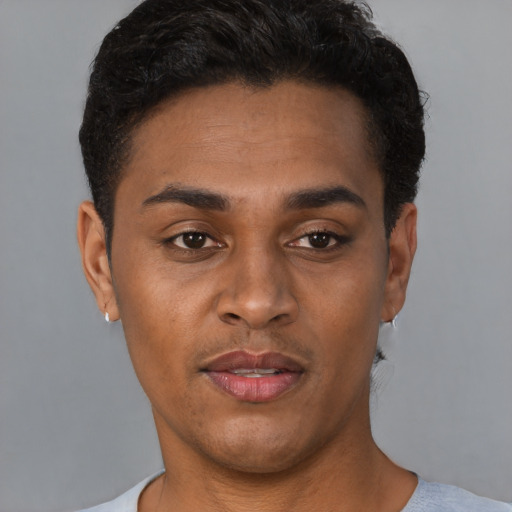 Joyful latino young-adult male with short  brown hair and brown eyes