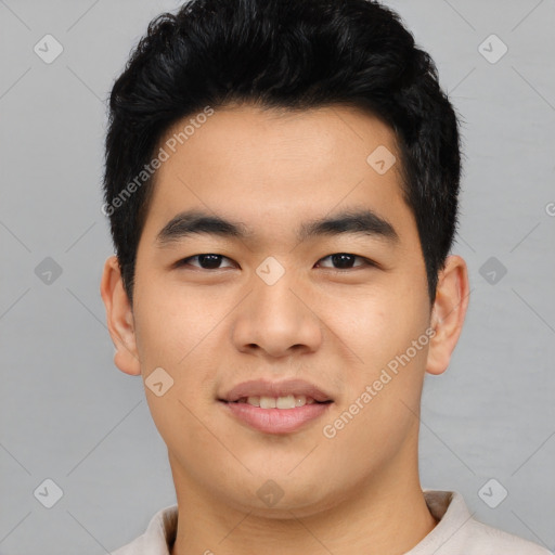 Joyful asian young-adult male with short  black hair and brown eyes