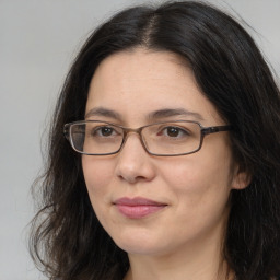 Joyful white adult female with long  brown hair and brown eyes