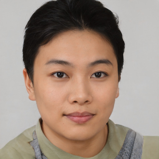 Joyful asian young-adult female with short  black hair and brown eyes