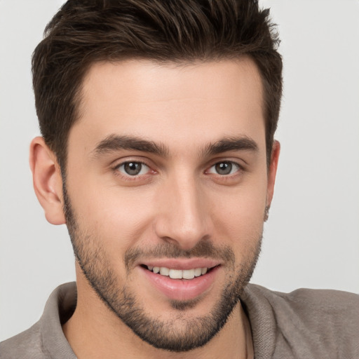 Joyful white young-adult male with short  brown hair and brown eyes