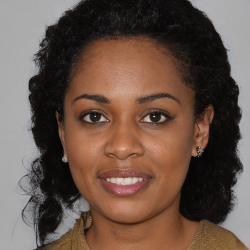 Joyful black young-adult female with medium  black hair and brown eyes