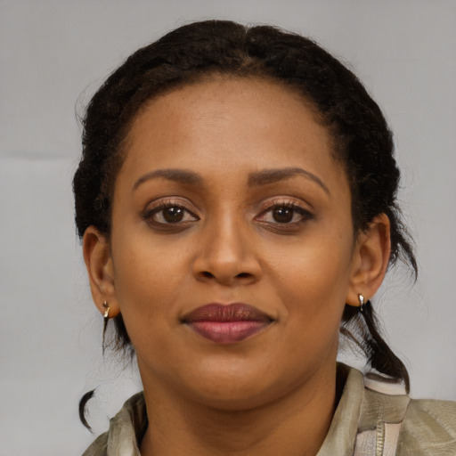 Joyful black young-adult female with medium  brown hair and brown eyes