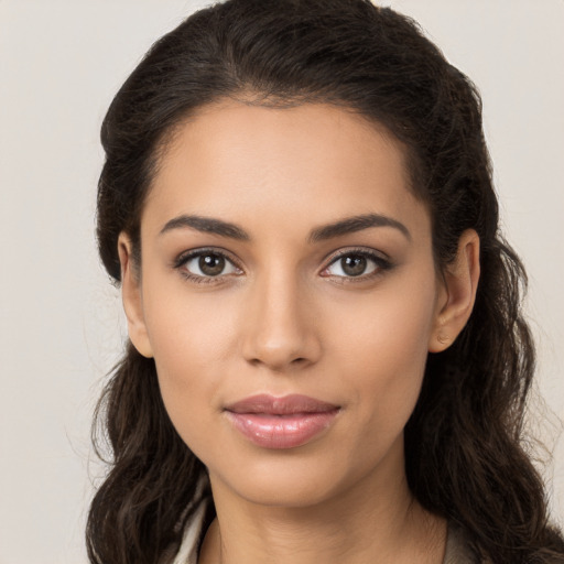 Joyful latino young-adult female with long  brown hair and brown eyes