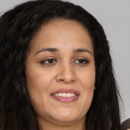 Joyful white adult female with long  brown hair and brown eyes