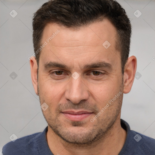 Joyful white adult male with short  brown hair and brown eyes