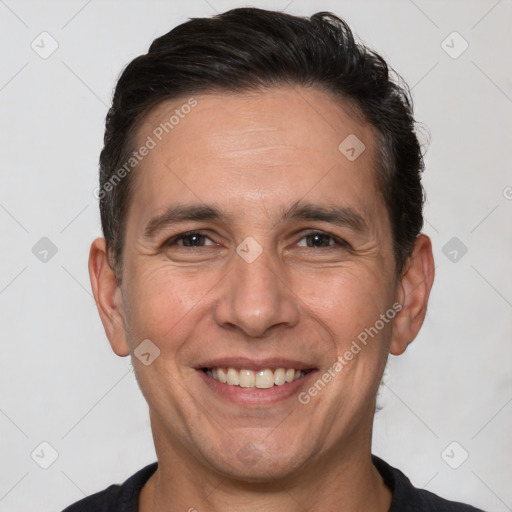 Joyful white adult male with short  brown hair and brown eyes