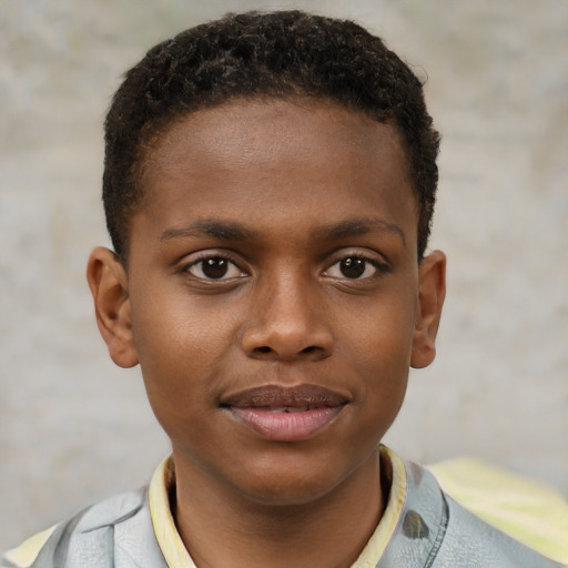Joyful black child male with short  brown hair and brown eyes