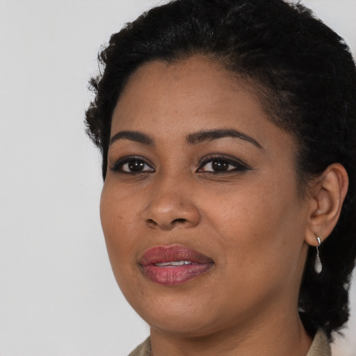 Joyful black young-adult female with short  brown hair and brown eyes