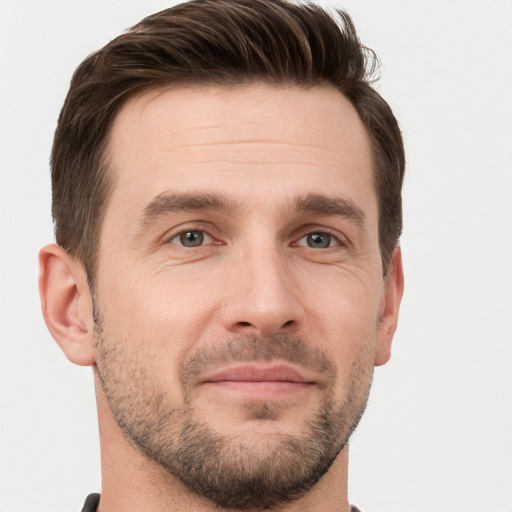 Joyful white young-adult male with short  brown hair and grey eyes