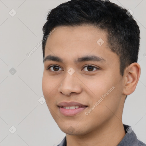 Joyful latino young-adult male with short  black hair and brown eyes